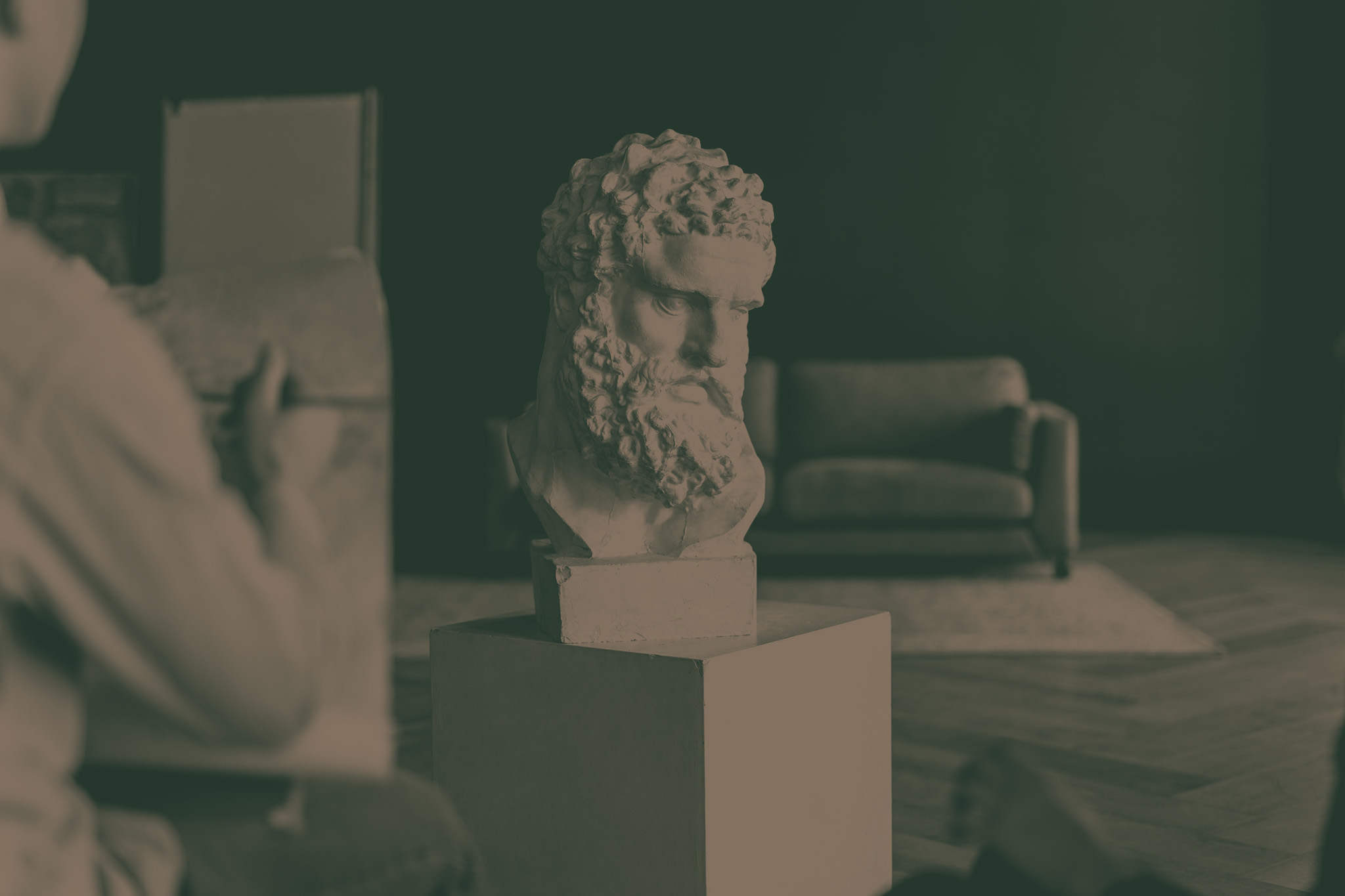 Young white student drawing plaster bust during class in art sch